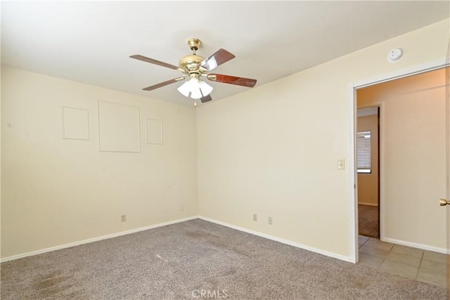 unfurnished room featuring ceiling fan and carpet