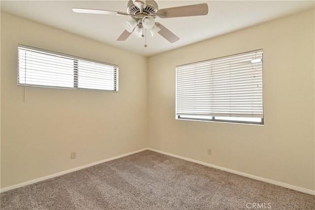 carpeted spare room featuring ceiling fan