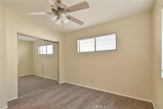 unfurnished bedroom featuring a closet, ceiling fan, and carpet flooring