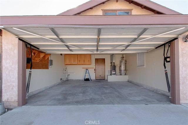 garage with water heater and a carport