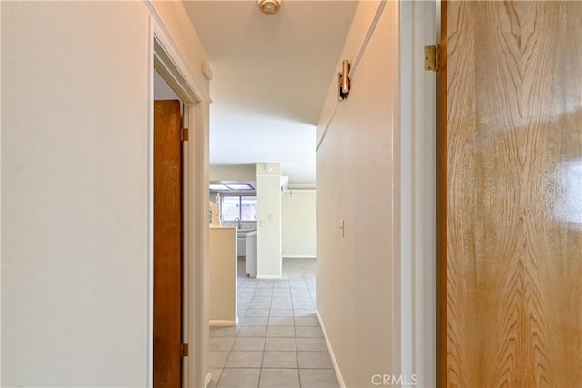 corridor with light tile patterned flooring