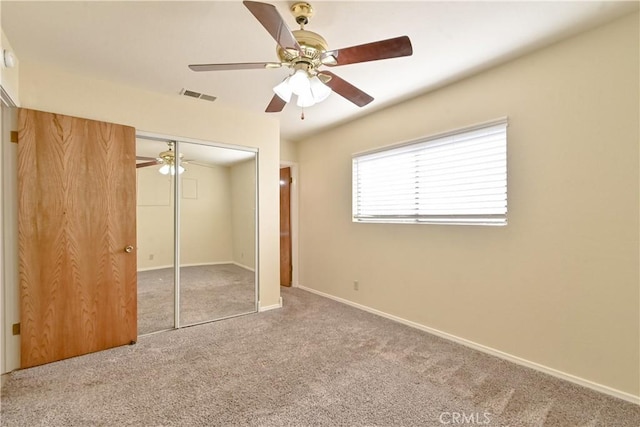 unfurnished bedroom featuring a closet, ceiling fan, and carpet floors