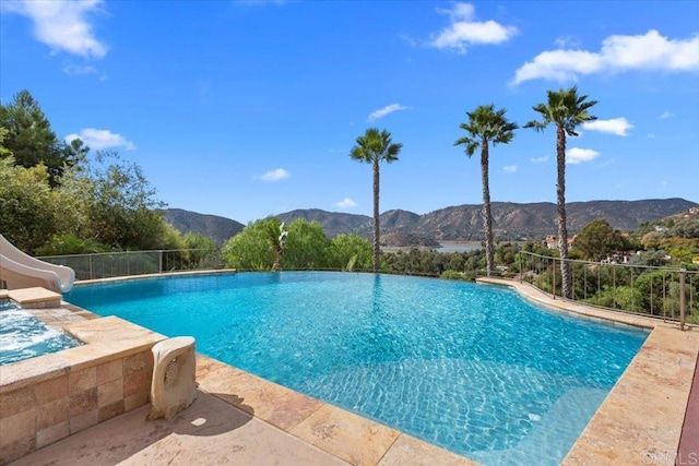 view of swimming pool with a mountain view and a water slide