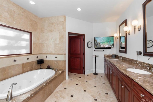 bathroom with tiled tub and vanity