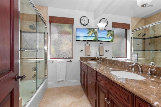 bathroom featuring vanity and combined bath / shower with glass door