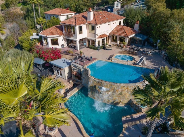 view of swimming pool with an in ground hot tub and a patio area