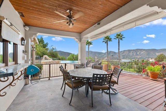 view of patio with ceiling fan and a water and mountain view