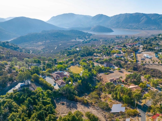 drone / aerial view featuring a water and mountain view