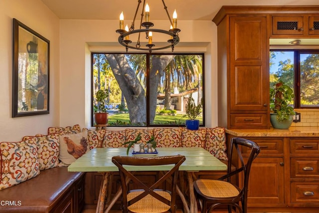 dining space featuring a chandelier and breakfast area