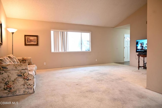 living room featuring lofted ceiling and carpet