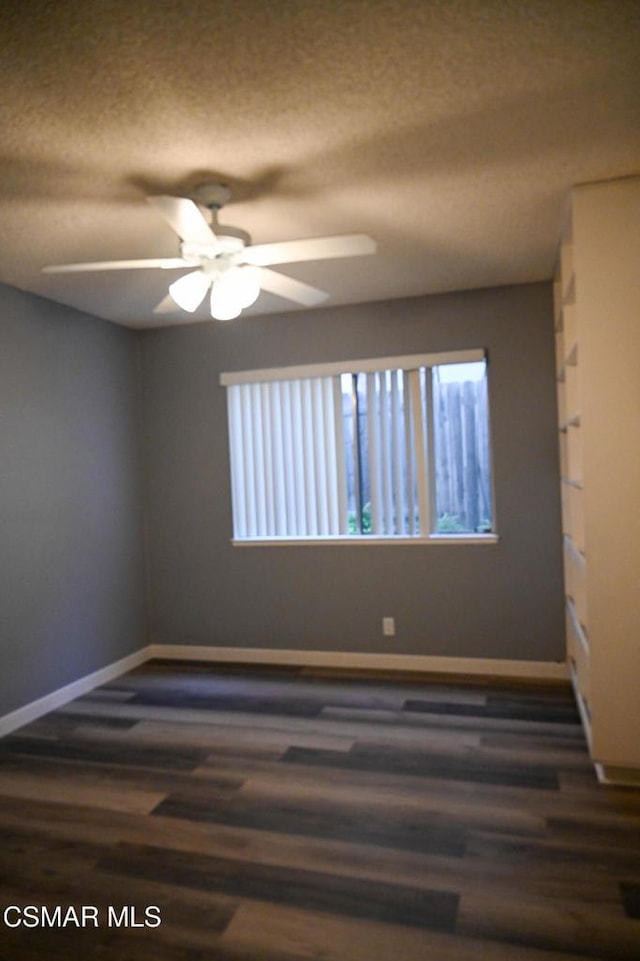 spare room featuring ceiling fan, a textured ceiling, and dark hardwood / wood-style flooring