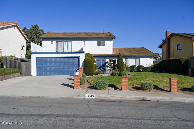 view of front facade with a garage and a front lawn