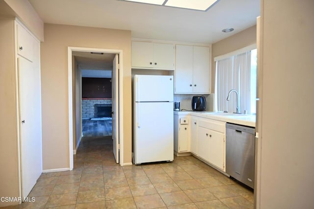 kitchen featuring white cabinetry, sink, stainless steel dishwasher, and white refrigerator