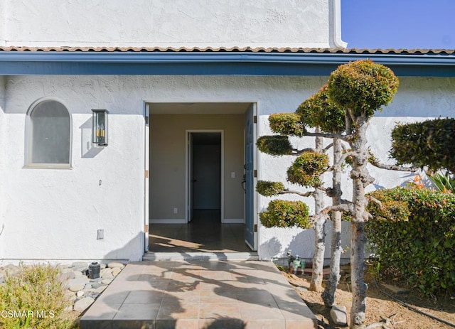 doorway to property with a patio