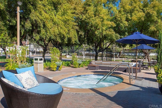 view of pool with a hot tub and a patio