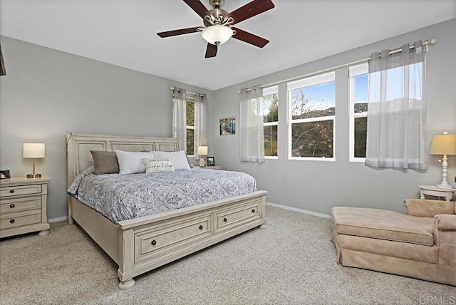 bedroom featuring light colored carpet and ceiling fan