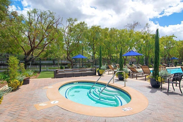 view of pool featuring a community hot tub and a patio