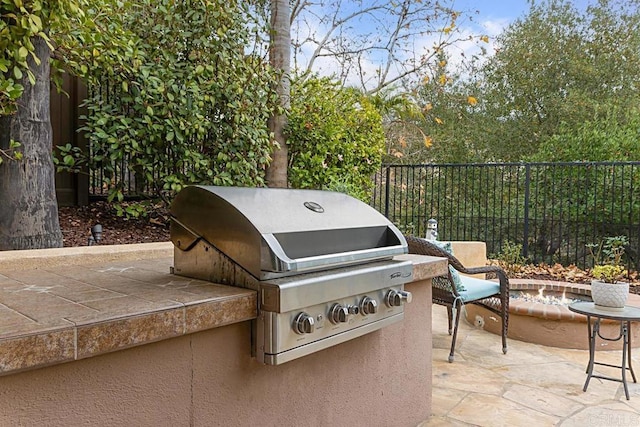 view of patio with area for grilling and exterior kitchen