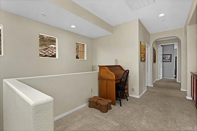 corridor featuring light colored carpet