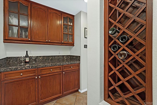 wine area with indoor bar and light tile patterned floors