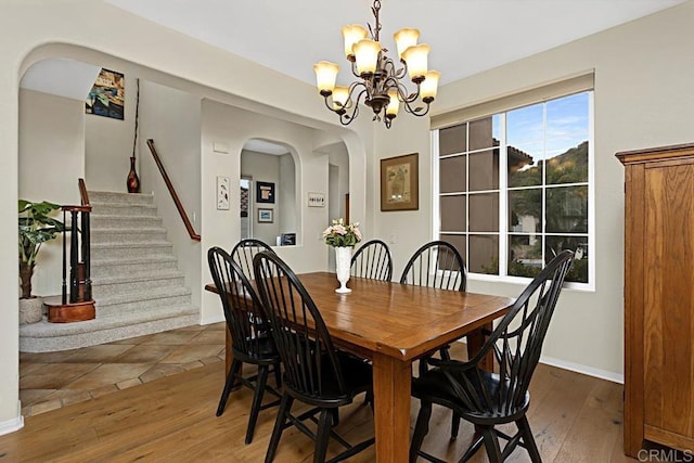 dining room featuring dark wood-type flooring and an inviting chandelier