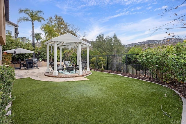 view of yard with a gazebo, a mountain view, and a patio