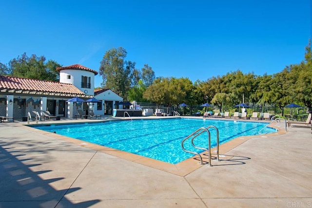 view of swimming pool with a patio