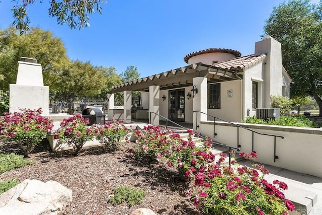 rear view of property featuring cooling unit