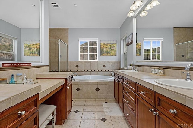 bathroom featuring tile patterned floors, plus walk in shower, and vanity