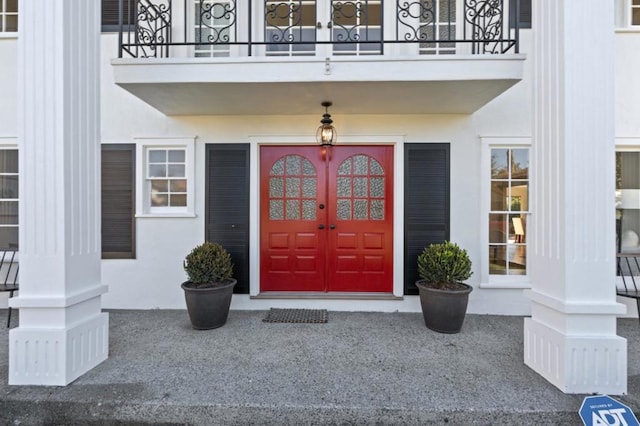 property entrance with a balcony and french doors