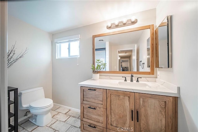 bathroom with toilet and vanity