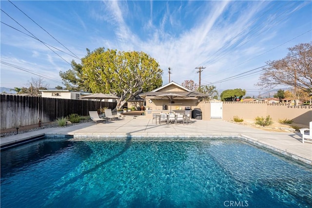 view of swimming pool with a patio area