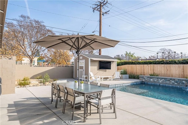 view of swimming pool with a patio area and a storage shed