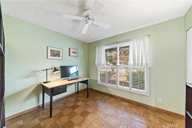 office featuring parquet flooring, ceiling fan, and a textured ceiling