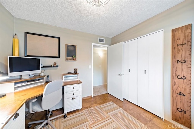 office area featuring light hardwood / wood-style floors and a textured ceiling