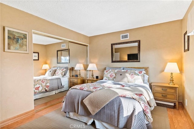 bedroom featuring light hardwood / wood-style flooring and a closet