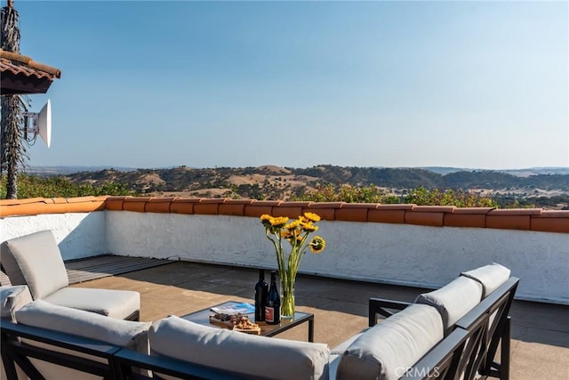 view of patio / terrace featuring a mountain view and an outdoor hangout area