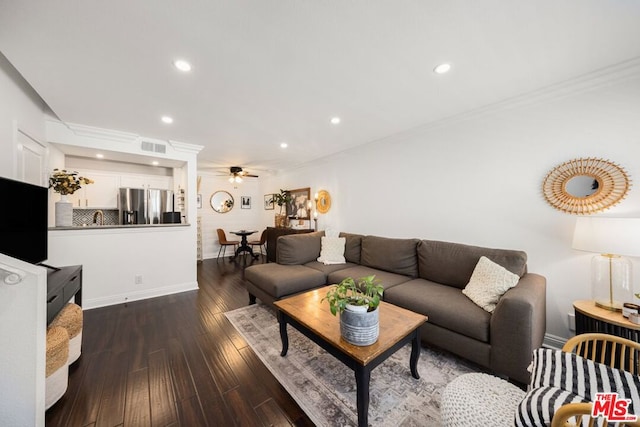 living room with ceiling fan, dark hardwood / wood-style flooring, and crown molding