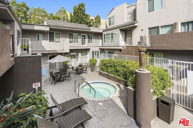 view of pool featuring a community hot tub and a patio