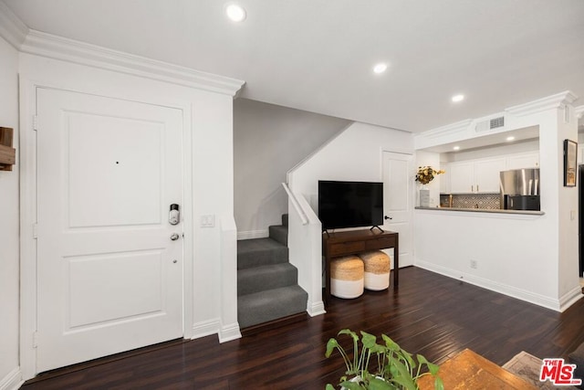 foyer with crown molding and dark hardwood / wood-style floors