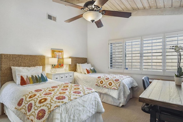 bedroom with ceiling fan, carpet flooring, and vaulted ceiling with beams