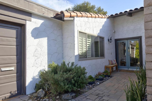 view of exterior entry featuring french doors