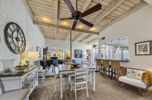 dining area featuring wooden ceiling, a towering ceiling, beam ceiling, and ceiling fan