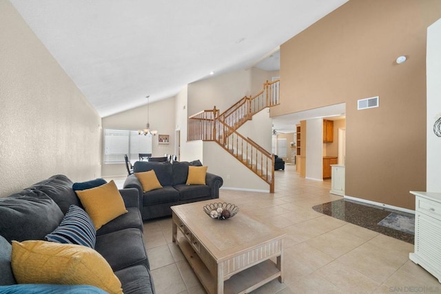 living room with high vaulted ceiling, light tile patterned floors, and an inviting chandelier