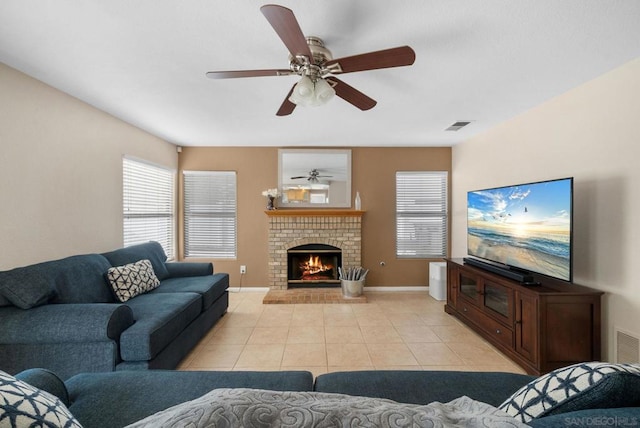 tiled living room with ceiling fan and a brick fireplace