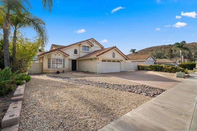 view of front facade with a garage and a mountain view