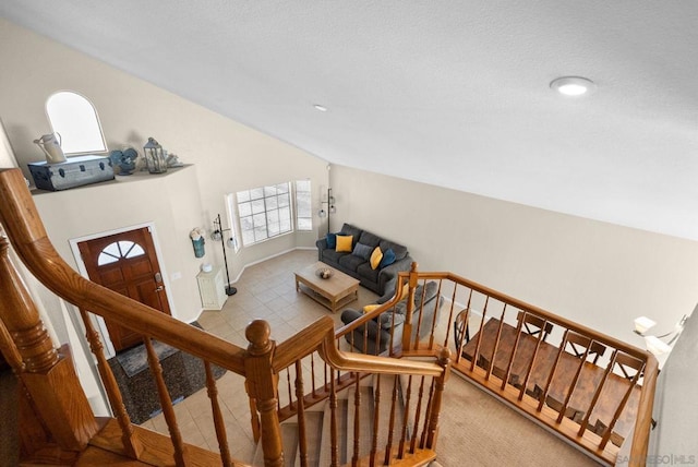 staircase with lofted ceiling