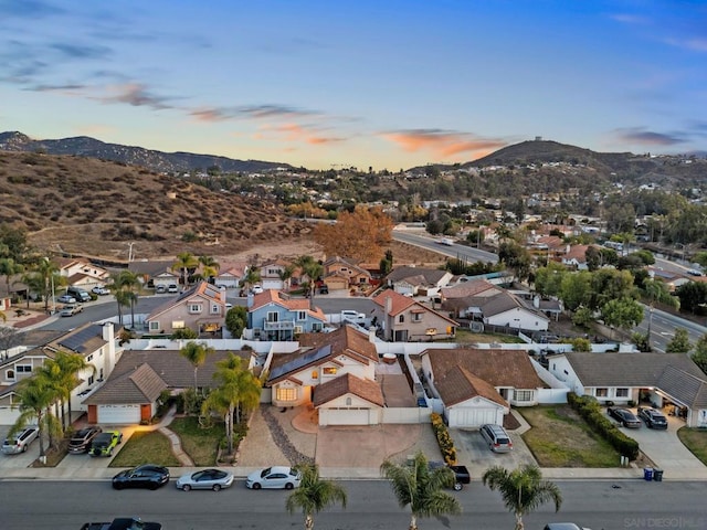 aerial view at dusk featuring a mountain view