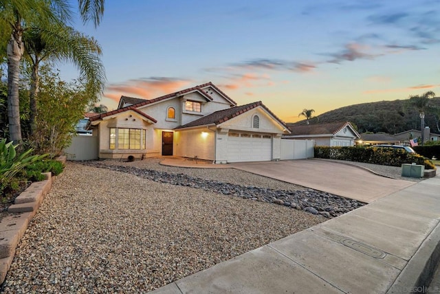 view of front facade with a mountain view and a garage