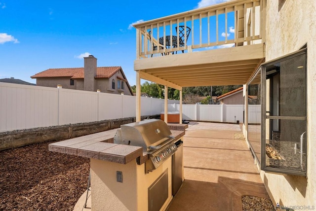 view of patio / terrace with a grill, a balcony, and area for grilling